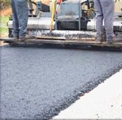 Asphalt overlay being laid on a road